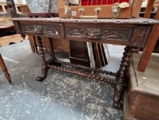 A VICTORIAN CARVED OAK TWO DRAWER SIDE TABLE.