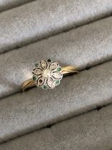 AN EMERALD AND DIAMOND CLUSTER TYPE RING, THE RING UNHALLMARKED ASSESSED AS 18ct GOLD SHANK AND 10ct