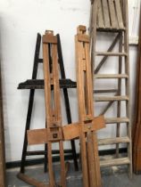 THREE ARTISTS EASELS AND A WOODEN STEP LADDER.