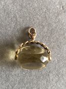 A VINTAGE LEMON QUARTZ PENDANT MOUNTED WITH A 9ct GOLD SWIVEL FITTING. WEIGHT 13.21grms.