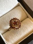 A VINTAGE 9ct GOLD GARNET SET OPEN WORK CLAW SET FLARED RING. FINGER SIZE O 1/2. WEIGHT 4.36grms