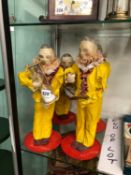 FOUR PAPIER MACHE FIGURES OF MEN HOLDING HOUR GLASSES SIGNED AND DATED 2004