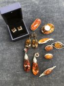 A COLLECTION OF AMBER BROOCHES EARRINGS ETC. MOSTLY MOUNTED IN SILVER