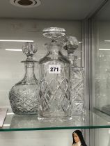 THREE CUT GLASS DECANTERS AND STOPPERS