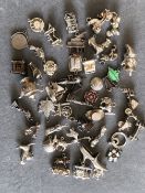 A LARGE COLLECTION OF SILVER CHARMS TO INCLUDE VINTAGE EXAMPLES, MOVEABLE CHARMS, ETC. GROSS
