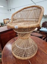 A WICKER STOOL.