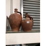 A GRADED SET OF THREE TERRACOTTA EWERS INCISED WITH WHITE LINES ON THE SHOULDERS