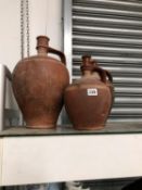A GRADED SET OF THREE TERRACOTTA EWERS INCISED WITH WHITE LINES ON THE SHOULDERS