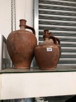 A GRADED SET OF THREE TERRACOTTA EWERS INCISED WITH WHITE LINES ON THE SHOULDERS