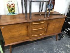 A RETRO ALFRED COX TEAK SIDEBOARD WITH DOORS FLANKING THE CENTRAL THREE DRAWERS