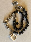 A BLACK FACET BEAD AND SILVER NECKLACE AND EARRING SUITE, STAMPED STERLING, JJ, TOGETHER WITH A