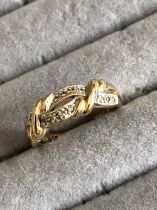 A 9ct HALLMARKED GOLD DIAMOND SET CROSS OVER STYLE RING. FINGER SIZE M. GROSS WEIGHT 2.57grms.