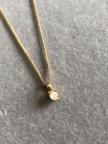 A 9ct HALLMARKED GOLD DIAMOND SOLITAIRE PENDANT SUSPENDED ON A 9ct HALLMARKED GOLD CURB CHAIN. CHAIN