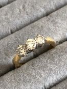 AN 18ct HALLMARKED GOLD THREE STONE DIAMOND RING. DIAMOND WEIGHT AS STATED 0.75cts. FINGER SIZE M.