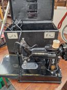 A SINGER 222K MINIATURE SEWING MACHINE