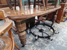 A VICTORIAN AESTHETIC OAK DINING TABLE.