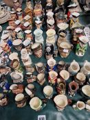 A LARGE COLLECTION OF ROYAL DOULTON AND OTHER TOBY AND CHARACTER JUGS.
