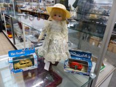 A BISQUE HEADED DOLL AND STAND, A CORGI BEATLES DIE CAST TAXI TOGETHER WITH A CORGI ITALIAN JOB MINI