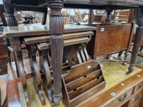 A NEST OF OAK TABLES, A MAGAZINE STAND AND A STATIONARY RACK.