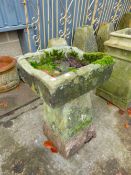 A SMALL STONE TROUGH ON STADDLE BASE.
