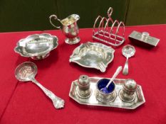 HALLMARKED SILVER TO INCLUDE A TOAST RACK, CREAM JUG, TWO SIFTER SPOONS, AN ASHTRAY, A SWEETMEAT