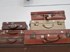 FIVE VARIOUS SUITCASES MAINLY IN LEATHER