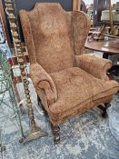 AN EARLY 20th C. QUEEN ANNE STYLE WING BACK ARMCHAIR.