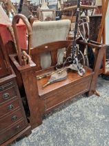 AN OAK HALL SET STICK STAND WITH VARIOUS WALKING STICKS.