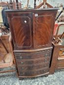A MAGONANY BOW FRONT CABINET ON CHEST,