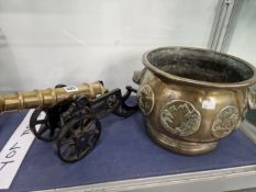 AN ORIENTAL POLISHED BRONZE PLANTER TOGETHER WITH A BRASS CANNON ON AN IRON CARRIAGE