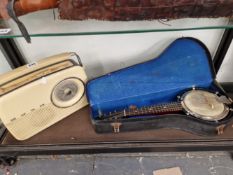 A CASED BANJO TOGETHER WITH A BUSH RADIO