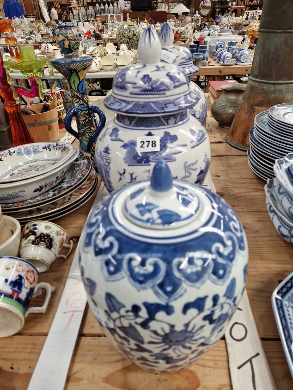 A PAIR OF WILLOW PATTERN COVERED JARS TOGETHER WITH A CHINESE EXAMPLE