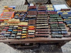 AN EXTENSIVE HORNBY DUBLO 00 GAUGE MODEL RAILWAY SET UP INCLUDING ENGINES CARRIAGES, AND TRACK