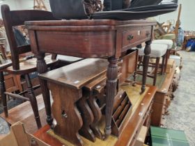 A GEORGE IV MAHOGANY FOLD OVER TABLE ON REEDED LEGS.