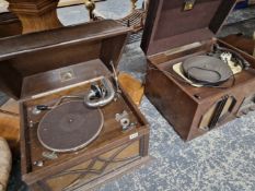 AN OAK CASED WIND UP GRAMOPHONE AND A HMV ELECTRIC GRAMOPHONE WITH GARRARD RECORD DECK.