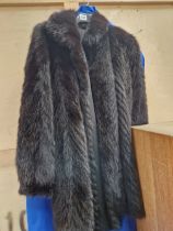 A VINTAGE BLACK FUR COAT.