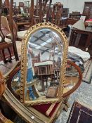 A GILT FRAMED MIRROR AND ONE OTHER.