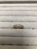 A 9ct HALLMARKED GOLD DIAMOND SET HALF ETERNITY CHANNEL SET RING. FINGER SIZE O 1/2. WEIGHT 1.