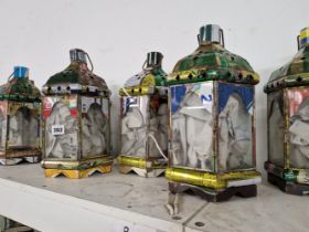 A SET OF SEVEN GLAZED TIN CANDLE LANTERNS.