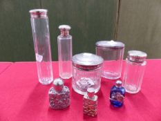 SIX SILVER TOPPED DRESSING TABLE JARS AND THREE SCENT BOTTLES.