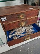 A SMALL FOUR DRAWER CHEST CONTAINING CUTLERY.