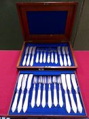 A VICTORIAN CASED CANTEEN FOR 12 OF MOTHER OF PEARL HANDLED FISH CUTLERY WITH HALLMARKED SILVER