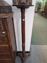 A MAHOGANY TORCHERE.