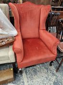 AN EDWARDIAN WING BACK CHAIR.
