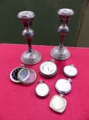 A PAIR OF HALLMARKED SILVER LOADED CANDLESTICKS TOGETHER WITH VARIOUS POCKET WATCHES.