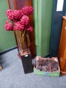 A DECORATIVE ARTIFICIAL FLOWER DISPLAY TOGETHER WITH A COLLECTION OF PINE CONES.