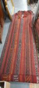 A TRIBAL FLAT WEAVE RUG 144 X 102cms, TOGETHER WITH ANOTHER FLAT WEAVE RUNNER 294 X 86cms (2)