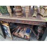 A CARVED AND PAINTED OAK CENTRE TABLE.