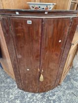 A GEORGIAN MAHOGANY CORNER CABINET.