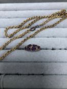 A 9ct HALLMAKED GOLD AND AMETHYST DRESS RING AND A 9ct GOLD ROPE CHAIN FITTED WITH A PLATED